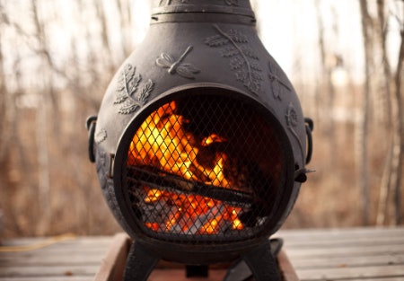 An Outdoor Log-Burning Chiminea Keeps the Vibe Alive Outside on Chillier Nights